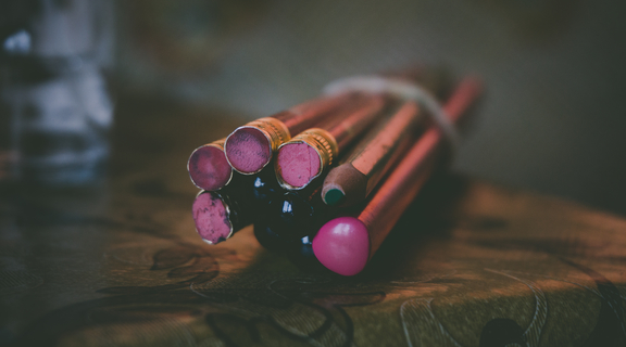 Homepage canva   wrapped purple pencils on table