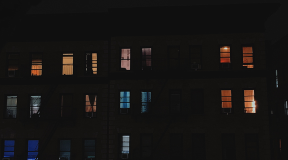 Homepage canva   multi storey building with open windows during nighttime